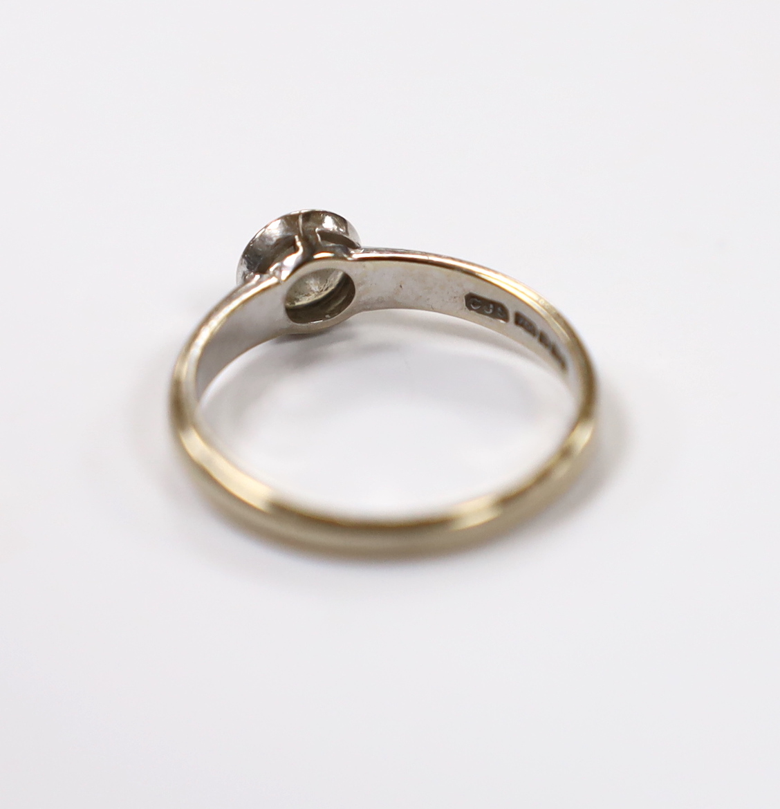 A modern 18ct white gold and collet set solitaire diamond ring size M, gross weight 3 grams.